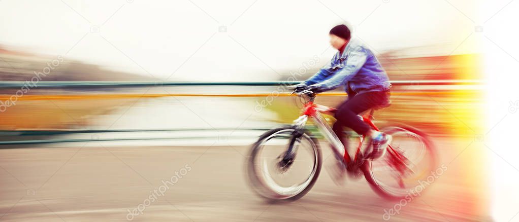 Abstract image of cyclist on the city roadway. Intentional motion blur
