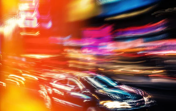Illumination and night lights of NYC. Abstract image of neon lights on the streets of New York City. Multiple exposure and intentional motion blur