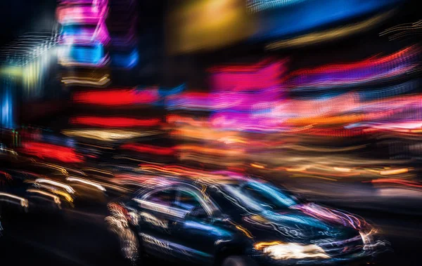 Illumination and night lights of NYC. Abstract image of neon lights on the streets of New York City. Multiple exposure and intentional motion blur
