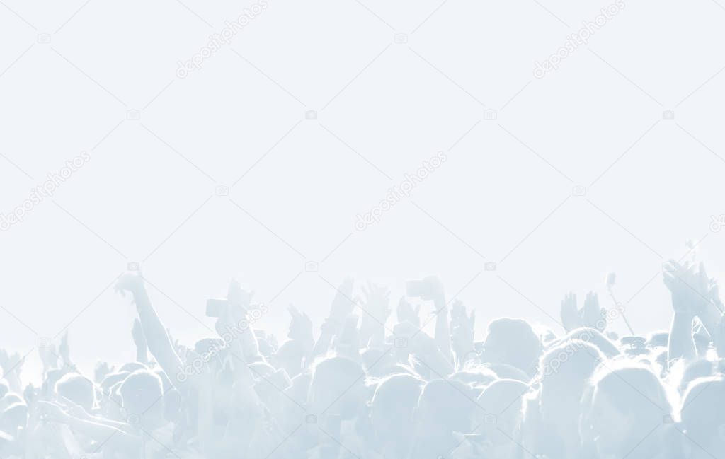 Crowd of spectators at a concert in light blue tonality. High key background with a people on an open playground at a concert. Abstract soft focus image with copy space