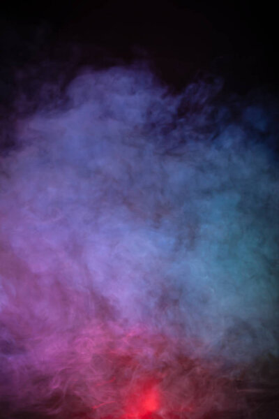Soft focus abstract image of colorful smoke on dark background. Texture and abstract art
