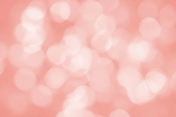 Holidays and design concept.  Abstract background. Image with blurred bokeh lights in trendy living coral color