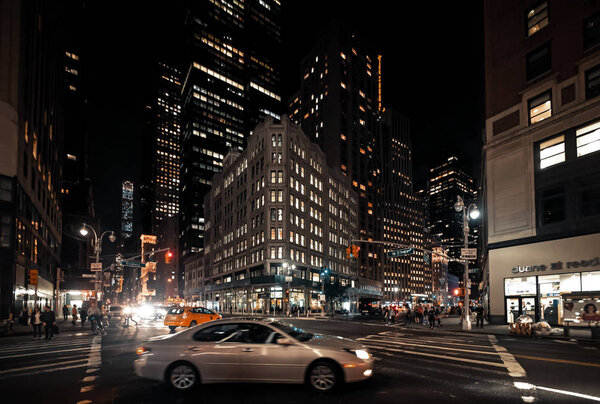 NEW YORK, USA - Sep 29, 2015: Streets of Manhattan at night. Manhattan is the most densely populated of the five boroughs of New York City