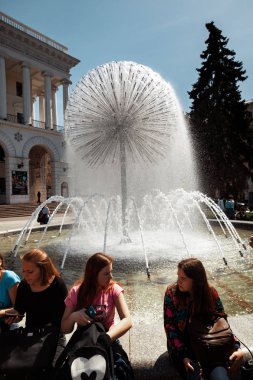 Genç insanlar Çeşme yakınlarında oturan bir dinlenme var