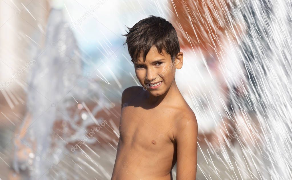 Happy children playing in a water fountain