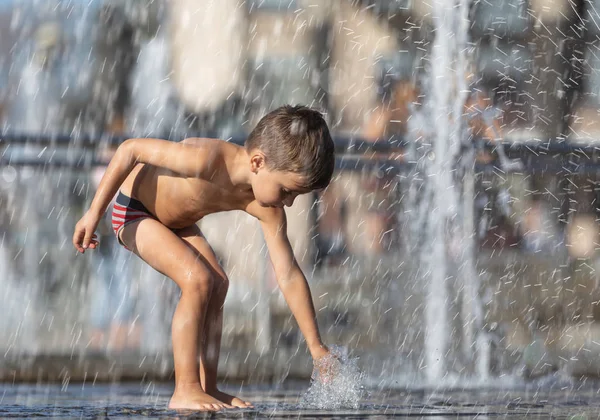 Crianças felizes brincando em uma fonte de água — Fotografia de Stock