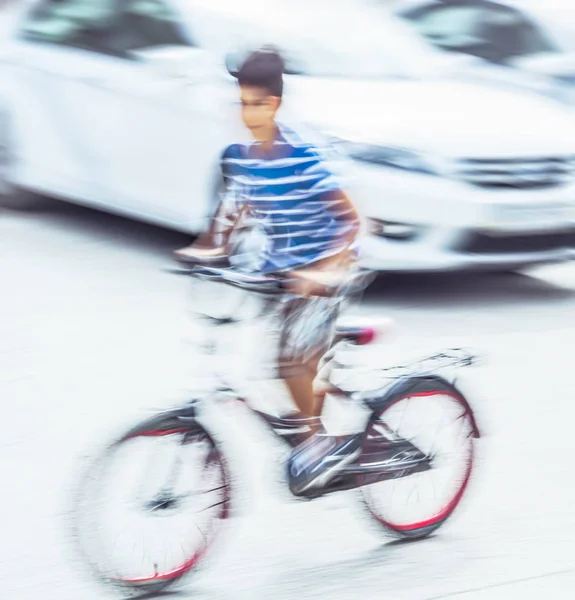 Dangerous city traffic situation with a boy on bicycle — Stock Photo, Image