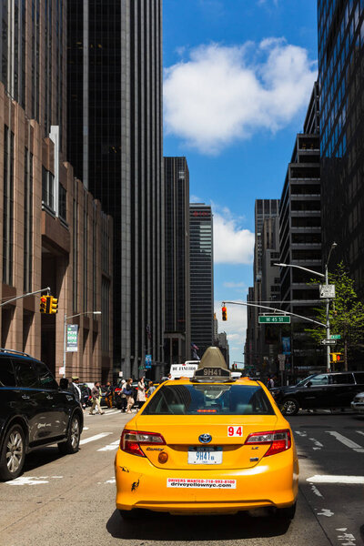 NEW YORK, USA - Apr 27, 2016: Yellow taxi on street of Manhattan in New York. City street scene with a yellow taxi cabs