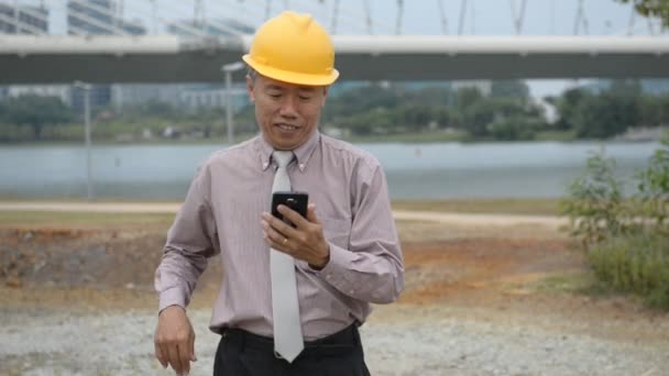 Азиатский Старший Бизнесмен Костюме Жёлтом Шлеме Телефону — стоковое видео