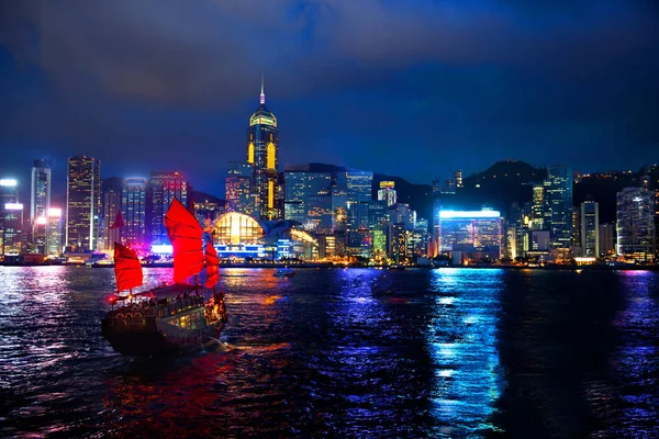 Victoria Harbour Hong Kong night view with junk ship on foregroun