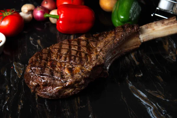 close-up shot of beautifully seared tomahawk steak, medium rare to rare