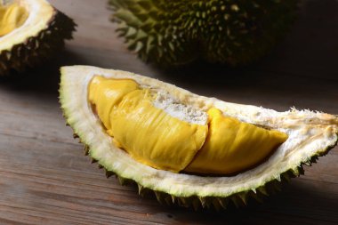Durian yırtık ve taze, ahşap masa üzerinde sarı renk ile durian kabuğu