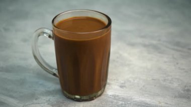 Kupada sütlü çay ya da gri arka planda Teh Tarık olarak bilinir.