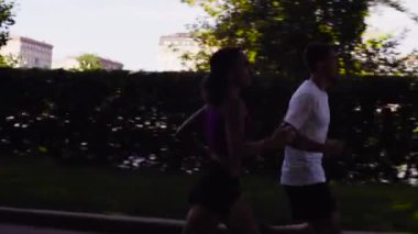 Kadın ve şehrin Nehri yakınında koşan adam