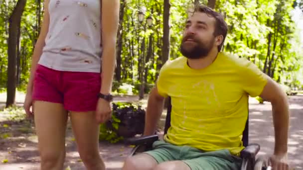 Portrait of happy young disable man on a walk in the park — Stock Video