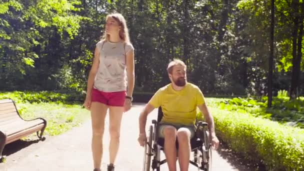 Portrait of happy young disable man on a walk in the park — Stock Video