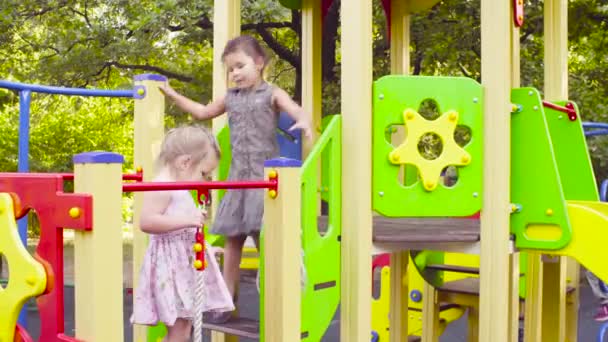 Three girls on a play complex on the playground — Stock Video