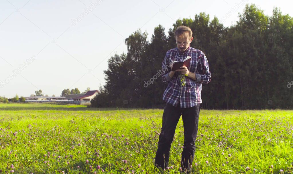 The man ecologist making notes in the diary