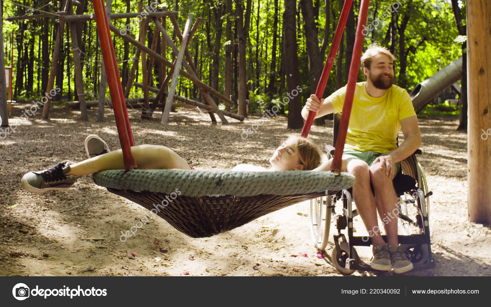Woman Is Lying On A Swing And A Man Is Pushing A Swing