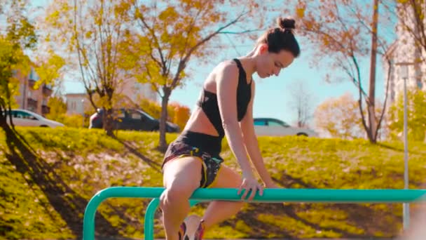 Female professional dancer performing choreographic exercises on parallel bars — Stock Video