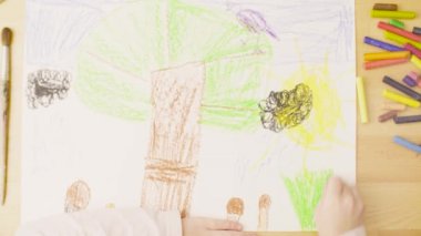 Bir kız bir odada bir masada kağıt üzerine pastel boya kalemi çizim