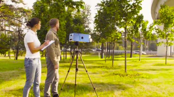 Two ecologist getting air samples near highway — Stock Video