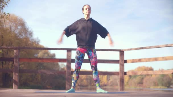 Mulher fazendo exercícios coreográficos na ponte no parque — Vídeo de Stock