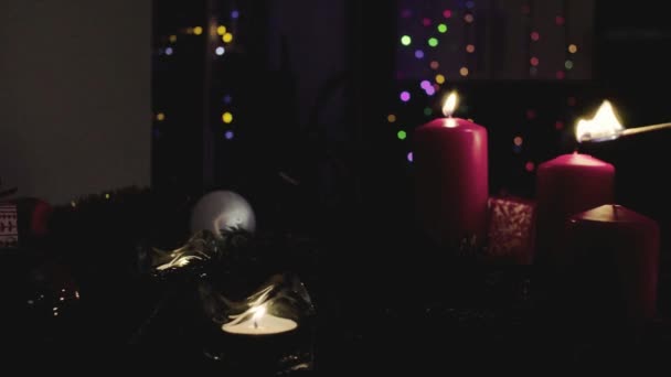 Female hands lighting candles in dark room — Stock Video