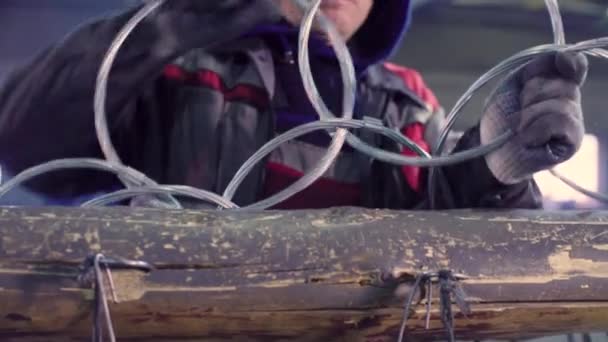 Hands of a worker manufacturing metal net in the factory — Stock Video