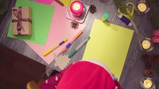 ショットをパンします トップは クリスマス ツリーを描画する小さな女の子の手を表示します クリスマスの装飾とテーブル — ストック動画