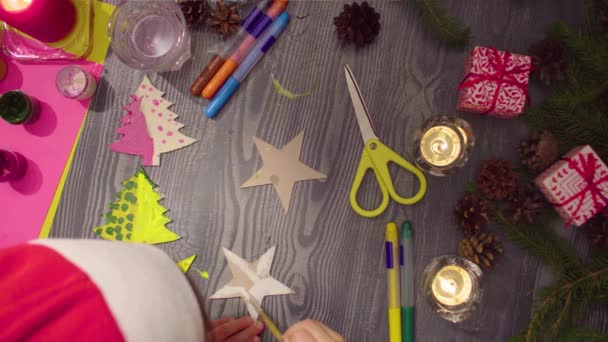 Little girls hands painting a cardboard stars — Stock Video