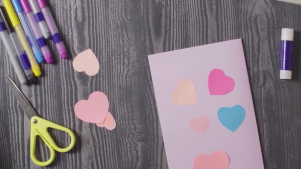Mädchen Hände kleben eine Karte. Valentinstag — Stockvideo