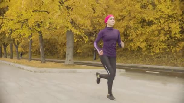 Joven deportista corriendo por el camino — Vídeo de stock