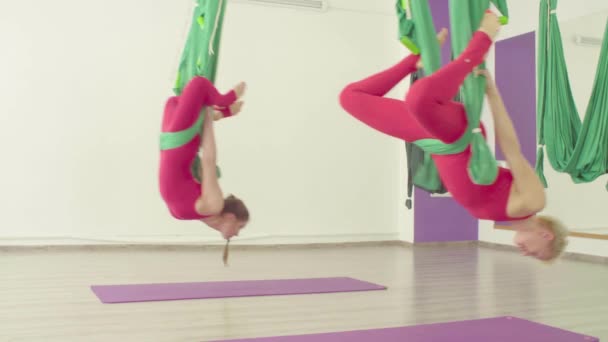 Aerial yoga. Two women flying in hammocks — Stock Video