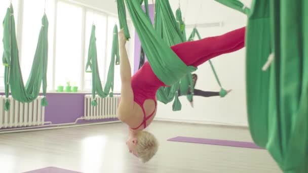 Aerial Yoga. zwei Frauen schwingen in Hängematten — Stockvideo