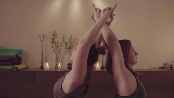 Paaryoga. zwei Frauen machen Yoga-Übungen zu zweit — Stockvideo