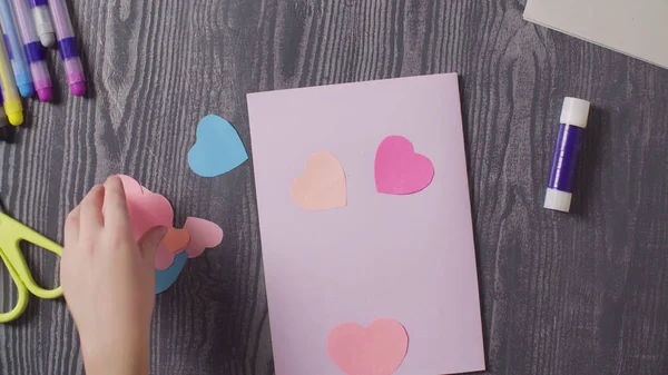 Girls hands glueing a card. Mothers Day — Stock Photo, Image