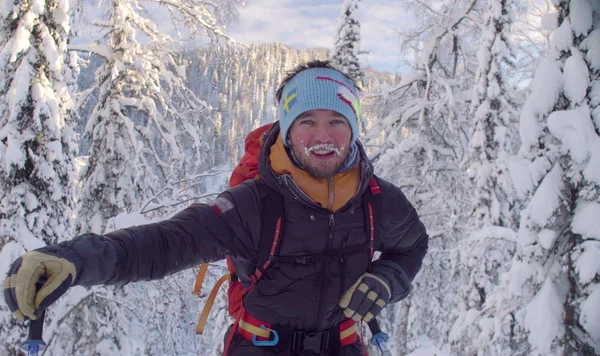 Porträt eines jungen Skifahrers im verschneiten Wald. — Stockfoto