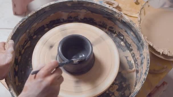 Colorazione di una pentola su una ruota di ceramica — Video Stock