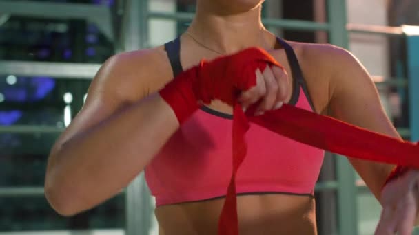 Woman athlete wrapping hand with bandage tape. — Stock Video