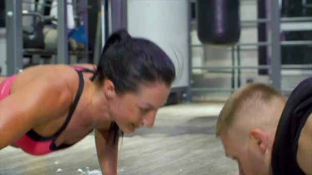 Two athletes doing push ups face to face and clapping hands — Stock Video