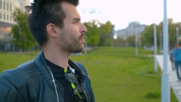 Portrait of a man in biker jacket smoking a cigarette — Stock Video