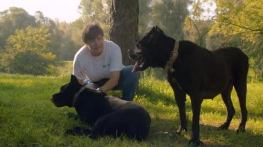 Kadın siyah boksör köpek okşayın