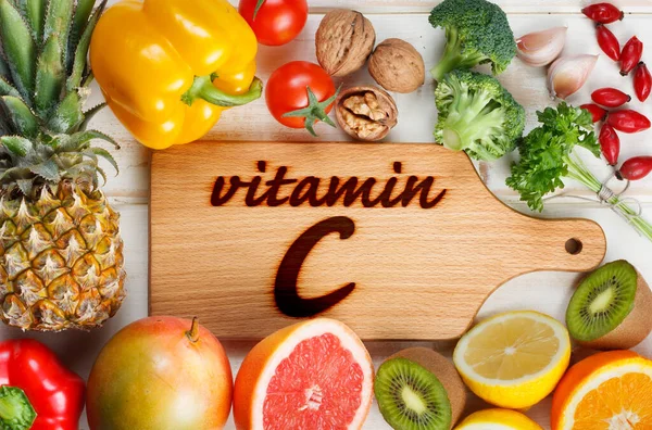 Vitamin C in fruits and vegetables. Natural products rich in vitamin C as oranges, lemons, dried fruits rose, red pepper, kiwi, parsley leaves, garlic, pineapple, chili and broccoli.