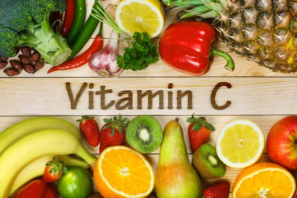 Vitamin C in fruits and vegetables. Natural products rich in vitamin C as oranges, lemons, dried fruits rose, red pepper, kiwi, parsley leaves, garlic, banana, pear, apple, pineapple, chili and broccoli.
