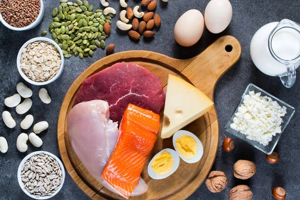 High protein food for body builders as meat, fish, dairy, eggs, buckwheat, oatmeal, nuts, bean, pumpkin seed and sunflower seed. Top view.