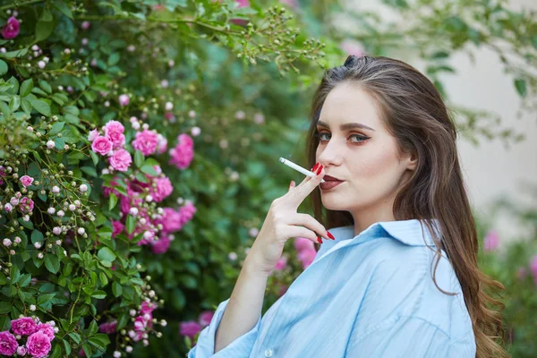 Mladá Žena Hnědými Vlasy Při Pohledu Kamery Venkovní Růžové Růže — Stock fotografie