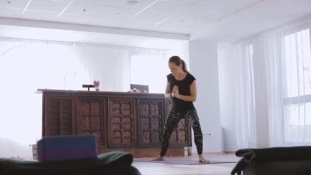 若い女性のヨガの実践やヨガの様々 なポーズを練習して屋内トレーナー — ストック動画