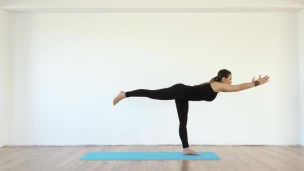 Young Female Yoga Teacher Studio Taking Various Poses White Wall — Stock Video