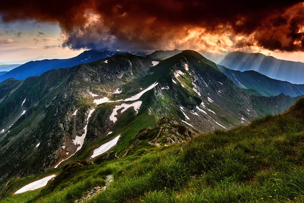 Fiery sunset in the  mountains, with a storm brewing at sunset